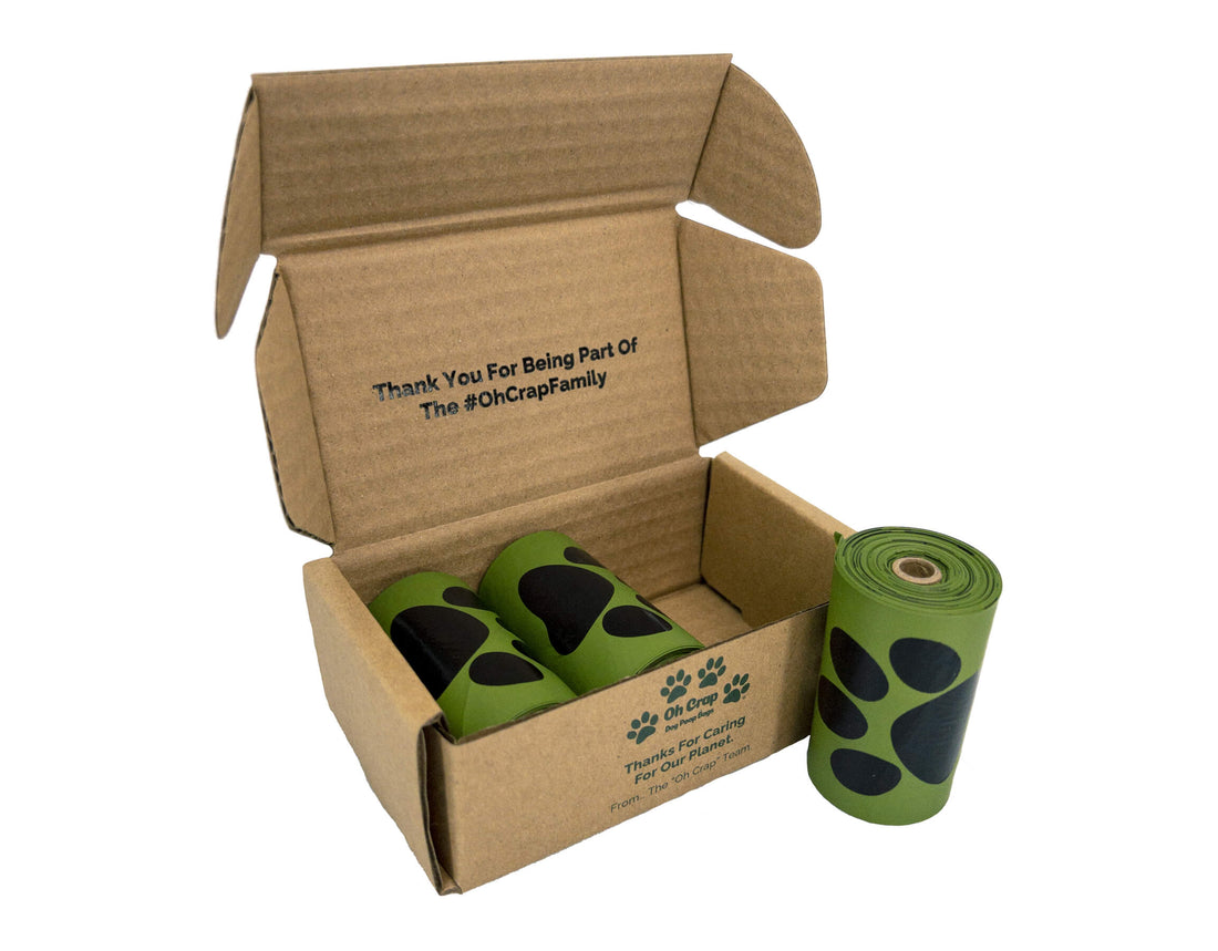 The front of the Oh Crap Non Plastic Biodegradable Compostable Dog Poop Bags 1 Month Pack with a roll standing to the right of it